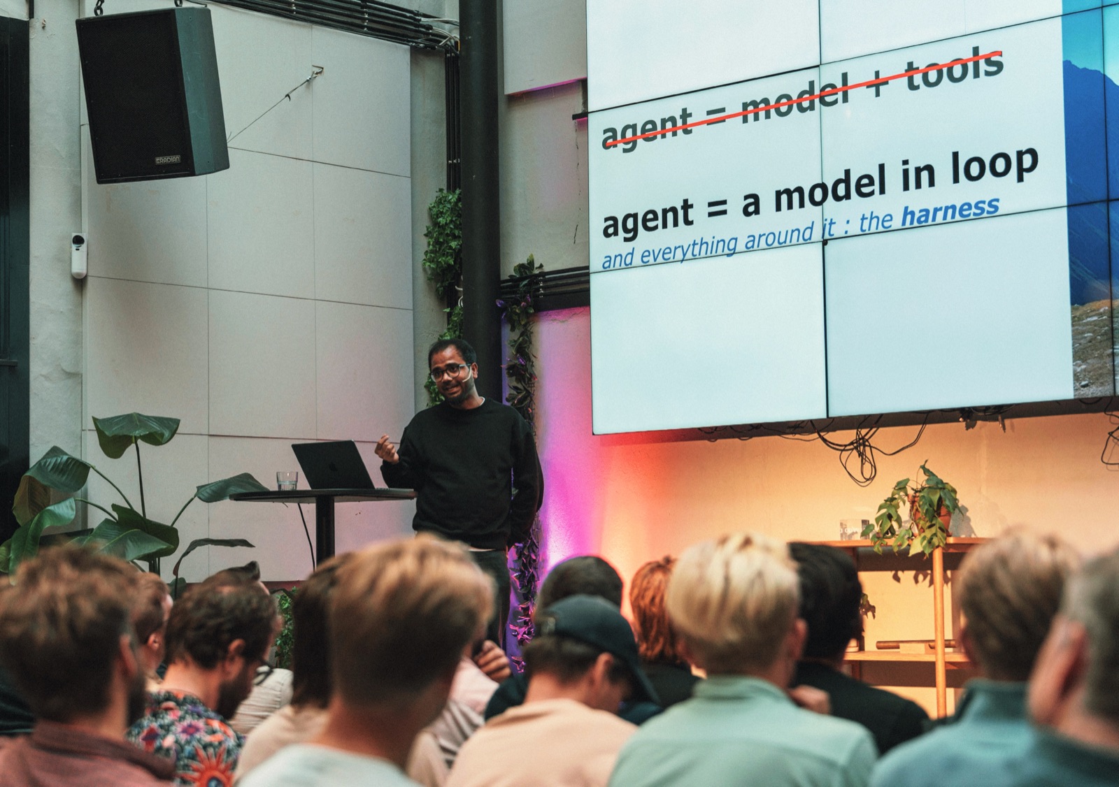 Avratanu Biswas speaking about AI agents at a meetup